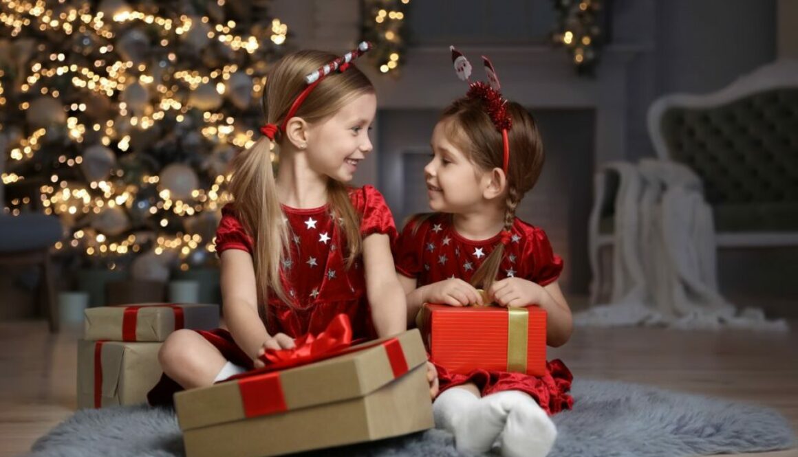 Children with Christmas gifts in daycare room
