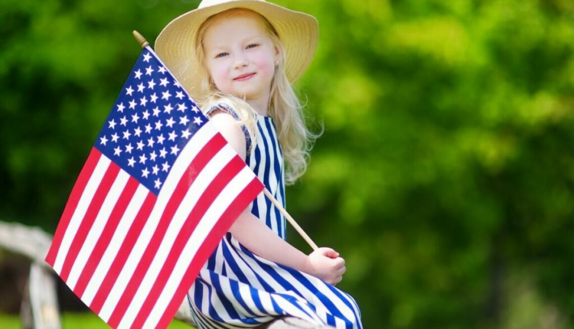 Cute little girl holding American flag