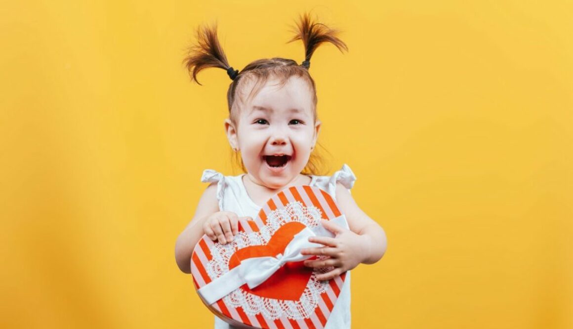 Daycare child smiling with a gift box