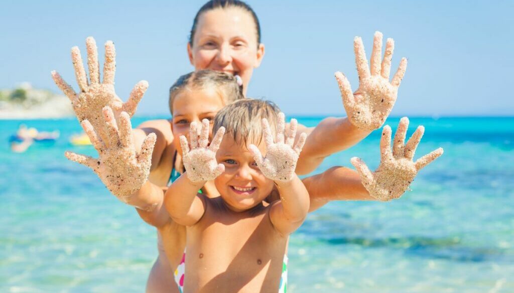 Daycare family playing on sandy beach