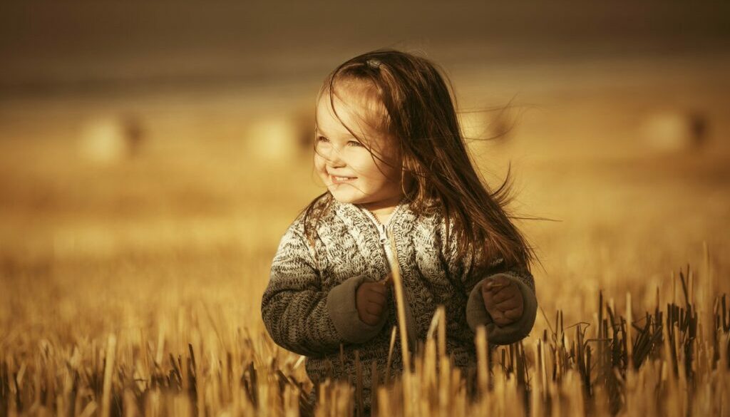 Smiling child walking in the daycare fields