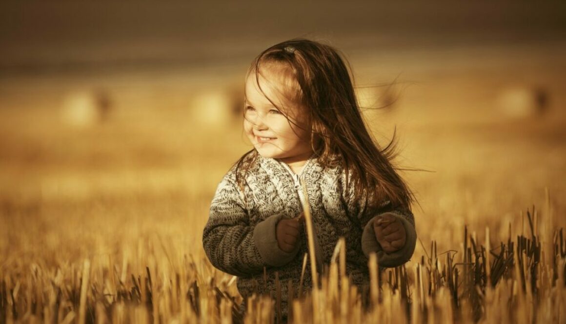 Smiling child walking in the daycare fields