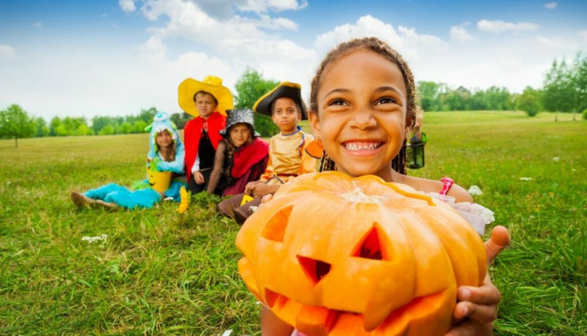 Little girl holding a halloween pumpkin