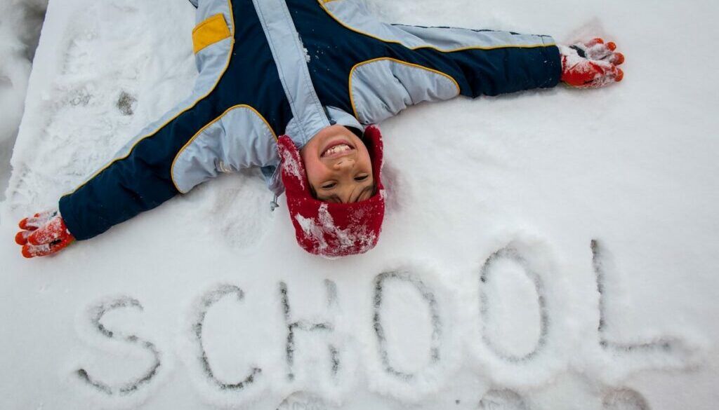 Daycare boy writing on snow