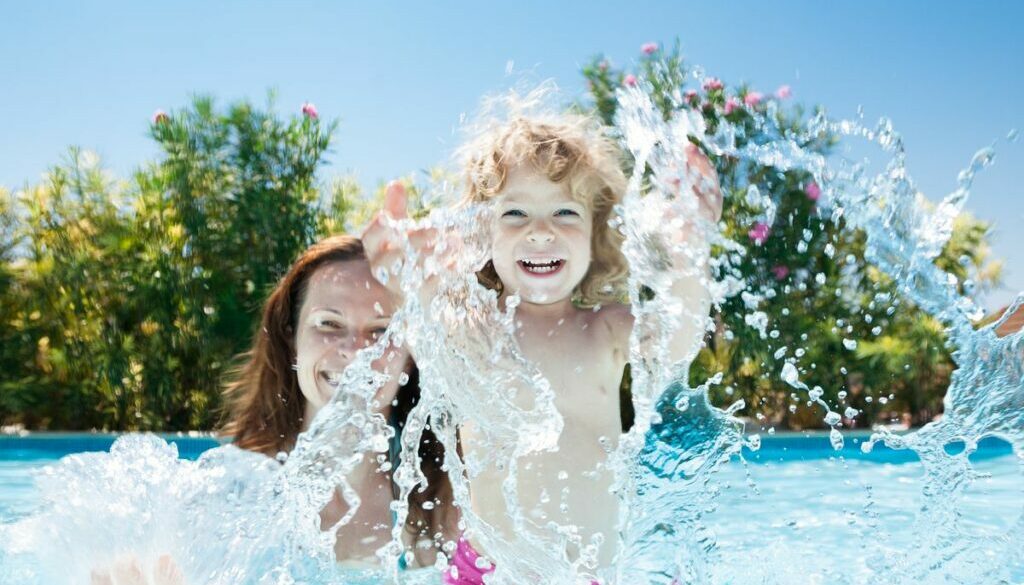 Daycare child with mom in swimming pool