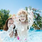 Daycare child with mom in swimming pool