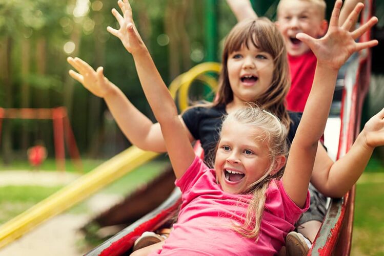 Daycare children playing on slide